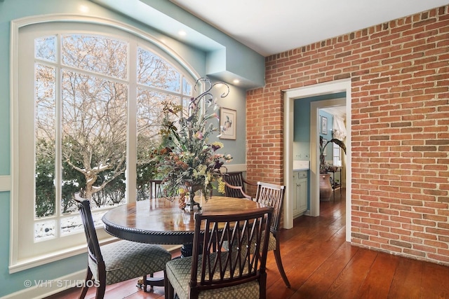 1930 Camphill Cir, Inverness, IL 60067 - dining room with a healthy amount of sunlight, dark wood-style floors, and brick wall