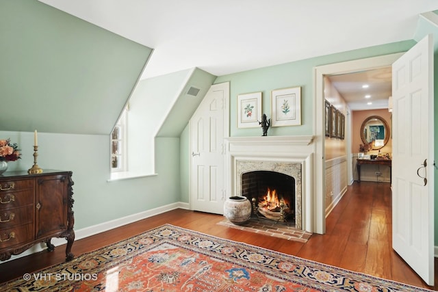 1930 Camphill Cir, Inverness, IL 60067 - living room with wood-type flooring, a warm lit fireplace, visible vents, and baseboards