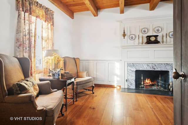 1930 Camphill Cir, Inverness, IL 60067 - living area featuring beam ceiling, wainscoting, a decorative wall, hardwood / wood-style flooring, and a high end fireplace