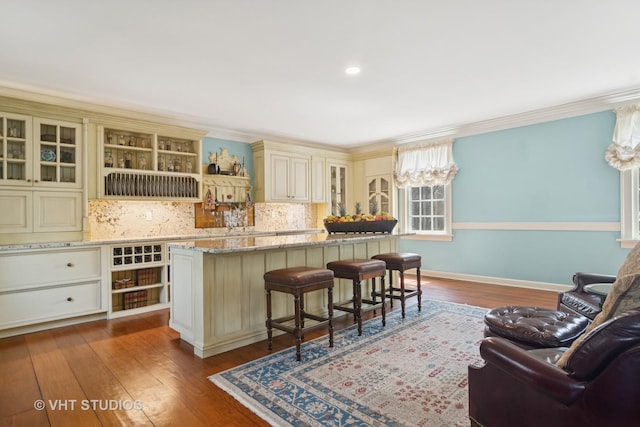 1930 Camphill Cir, Inverness, IL 60067 - bar with backsplash, baseboards, ornamental molding, and dark wood-type flooring