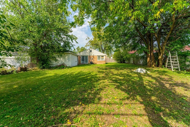 view of yard with fence and stairway