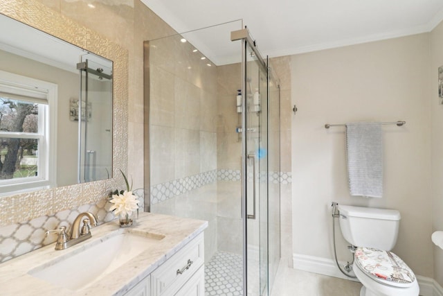 bathroom with crown molding, toilet, a stall shower, and vanity