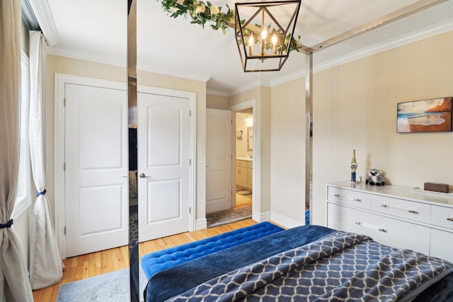 bedroom with ornamental molding, baseboards, a notable chandelier, and light wood-style floors