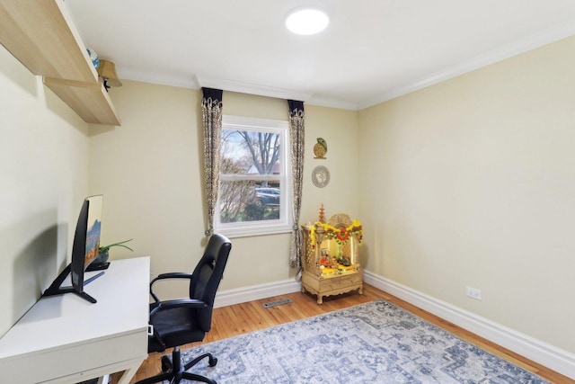 office area featuring crown molding, visible vents, baseboards, and wood finished floors