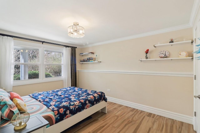 bedroom with a chandelier, light wood-style floors, baseboards, and ornamental molding