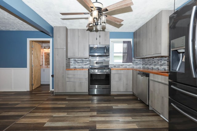 114 W Columbia St, Danvers, IL 61732 - kitchen with butcher block counters, a textured ceiling, dark wood finished floors, appliances with stainless steel finishes, and backsplash