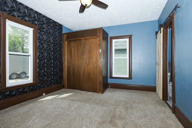 114 W Columbia St, Danvers, IL 61732 - unfurnished bedroom featuring baseboards, carpet, a closet, and a textured ceiling