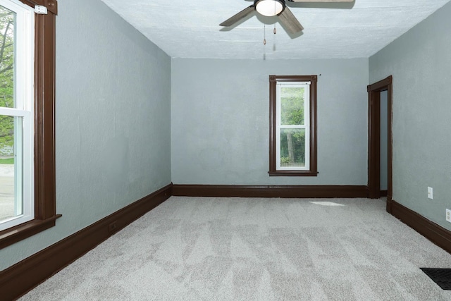 114 W Columbia St, Danvers, IL 61732 - carpeted empty room with baseboards and ceiling fan