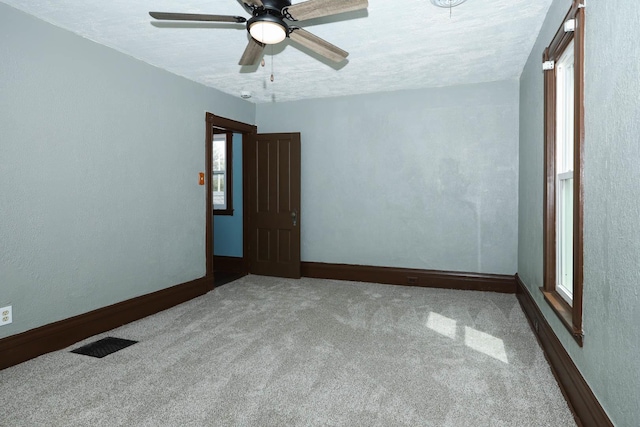 114 W Columbia St, Danvers, IL 61732 - empty room with visible vents, carpet flooring, baseboards, and ceiling fan