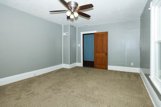 114 W Columbia St, Danvers, IL 61732 - unfurnished room with carpet floors, baseboards, a ceiling fan, and a textured ceiling