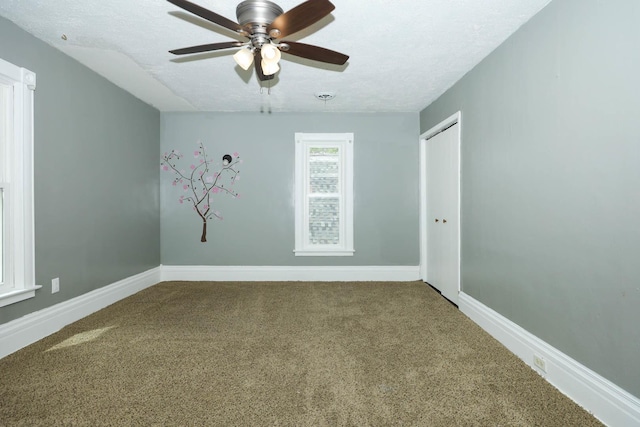 114 W Columbia St, Danvers, IL 61732 - carpeted empty room with baseboards, a ceiling fan, and a textured ceiling