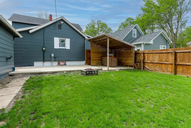 114 W Columbia St, Danvers, IL 61732 - rear view of property with a yard, a patio, and a fire pit