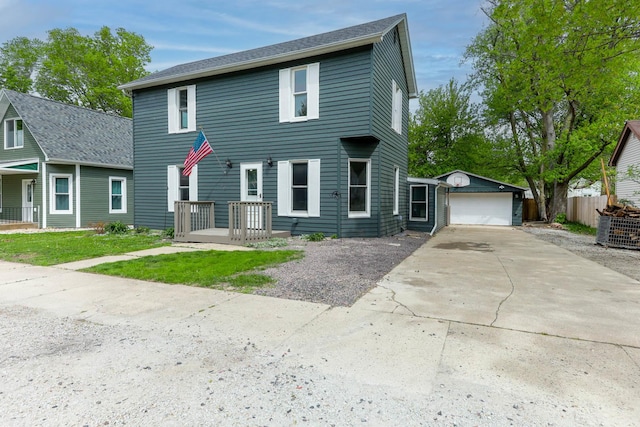 114 W Columbia St, Danvers, IL 61732 - colonial home featuring an outdoor structure, a garage, fence, and driveway