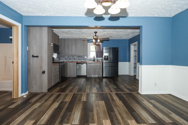 114 W Columbia St, Danvers, IL 61732 - kitchen featuring decorative backsplash, a textured ceiling, ceiling fan with notable chandelier, black appliances, and dark wood-style floors