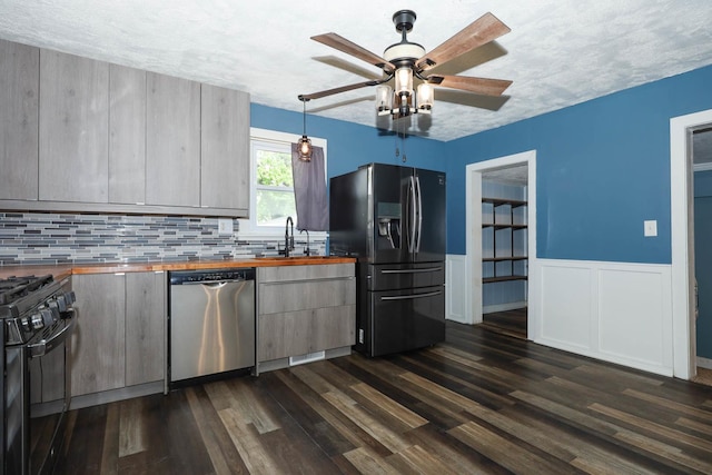 114 W Columbia St, Danvers, IL 61732 - kitchen featuring dark wood-style flooring, ceiling fan, a sink, butcher block countertops, and stainless steel appliances