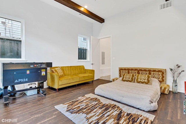 bedroom featuring wood finished floors, beamed ceiling, multiple windows, and visible vents