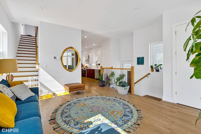 living area featuring baseboards, recessed lighting, and wood finished floors