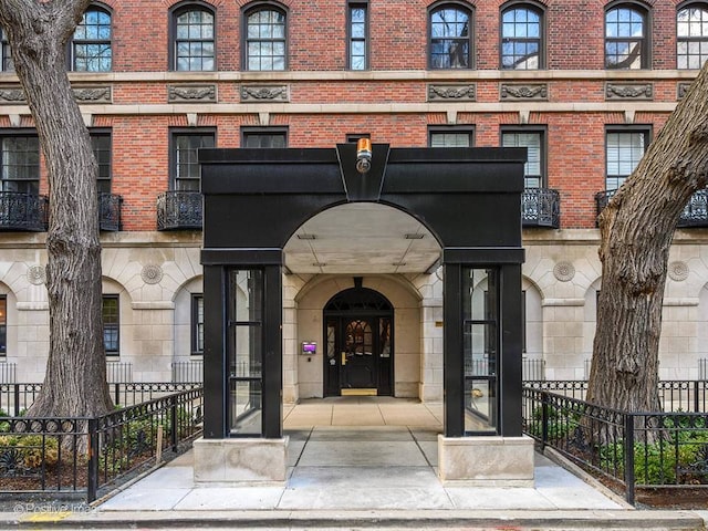 210 E Pearson St Unit 7B, Chicago, IL 60611 - property entrance featuring brick siding, fence, and stone siding