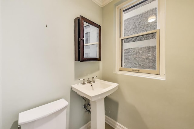 210 E Pearson St Unit 7B, Chicago, IL 60611 - half bathroom with baseboards, ornamental molding, and toilet