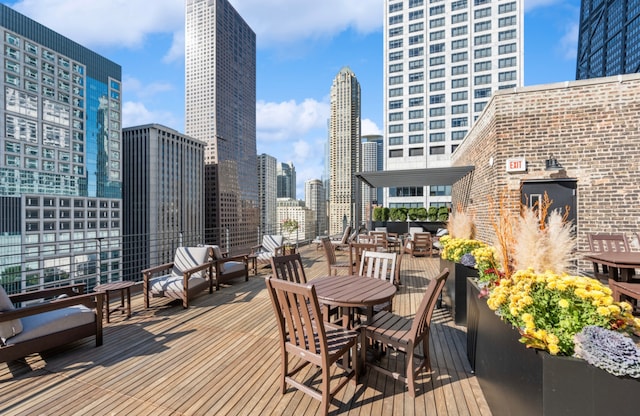 210 E Pearson St Unit 7B, Chicago, IL 60611 - deck featuring a view of city and outdoor dining area