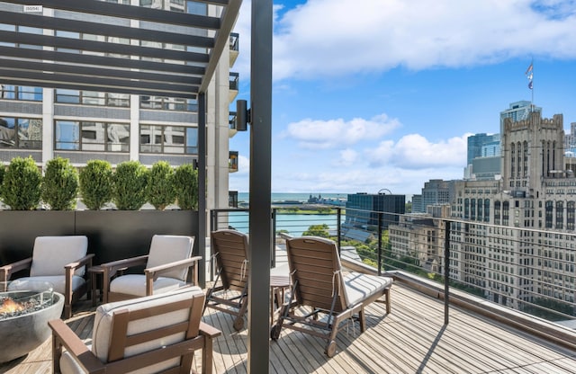 wooden deck featuring a water view and a city view