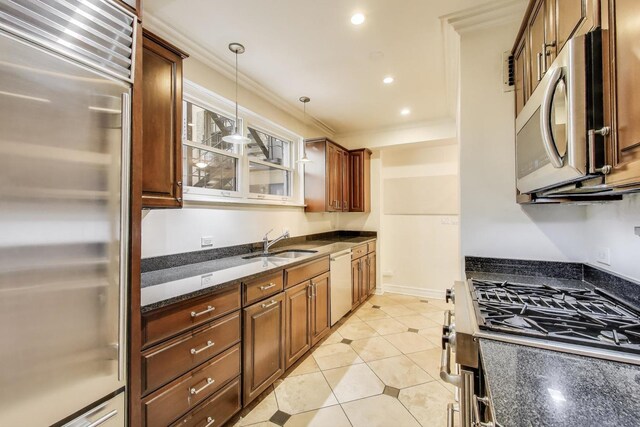 210 E Pearson St Unit 7B, Chicago, IL 60611 - kitchen featuring appliances with stainless steel finishes, a sink, ornamental molding, dark stone countertops, and pendant lighting