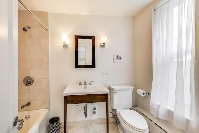 210 E Pearson St Unit 7B, Chicago, IL 60611 - bathroom featuring a sink, toilet, tile patterned floors, shower / washtub combination, and a baseboard radiator