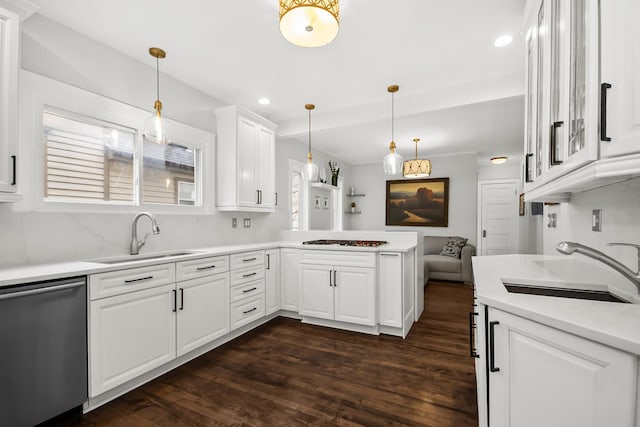 1130 Paulina St, Oak Park, IL 60302 - kitchen featuring a sink, white cabinets, a peninsula, and dishwasher