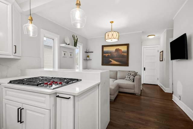 1130 Paulina St, Oak Park, IL 60302 - kitchen featuring a peninsula, light countertops, white cabinets, stainless steel gas cooktop, and dark wood finished floors