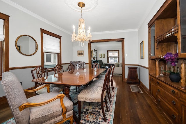1130 Paulina St, Oak Park, IL 60302 - dining room with crown molding, an inviting chandelier, dark wood-type flooring, visible vents, and baseboards