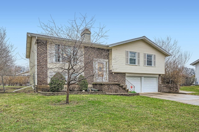 bi-level home featuring a front yard, a chimney, concrete driveway, and an attached garage