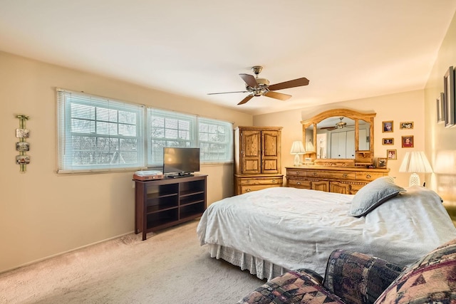 bedroom featuring ceiling fan and light carpet