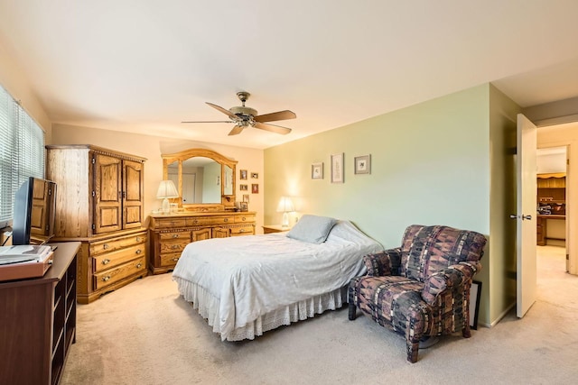 bedroom with ceiling fan and light carpet