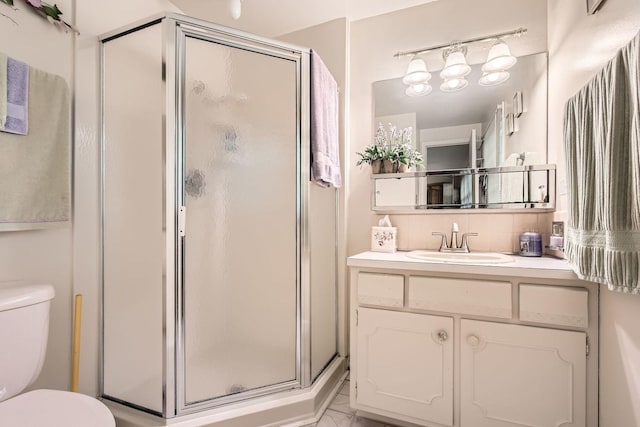 bathroom with a stall shower, marble finish floor, toilet, and vanity