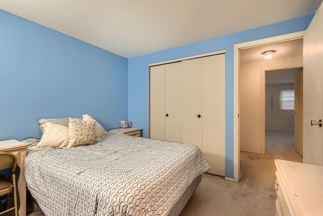 bedroom with light colored carpet and a closet