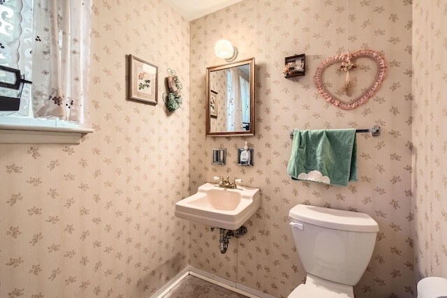 half bath with a sink and toilet