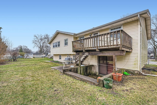 rear view of property with a wooden deck, stairway, and a yard