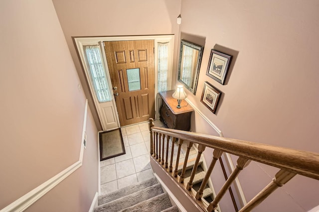 entryway with stairs and light tile patterned floors