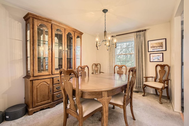dining room with baseboards, a chandelier, and light colored carpet