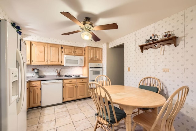 kitchen with light countertops, white appliances, light tile patterned floors, wallpapered walls, and ceiling fan