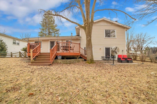 back of property with a fenced backyard and a deck