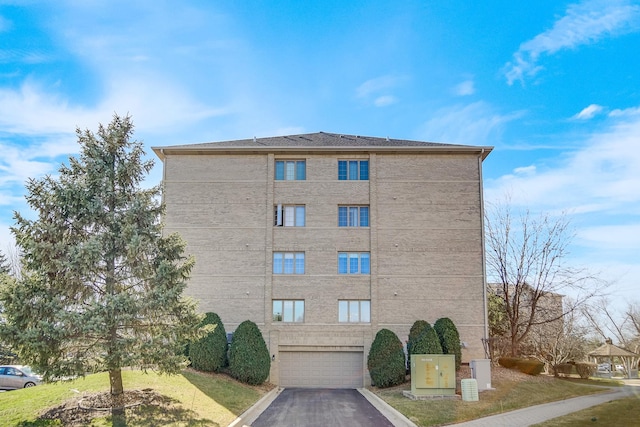 11850 Windemere Ct Unit 103, Orland Park, IL 60467 - view of building exterior with a garage and aphalt driveway