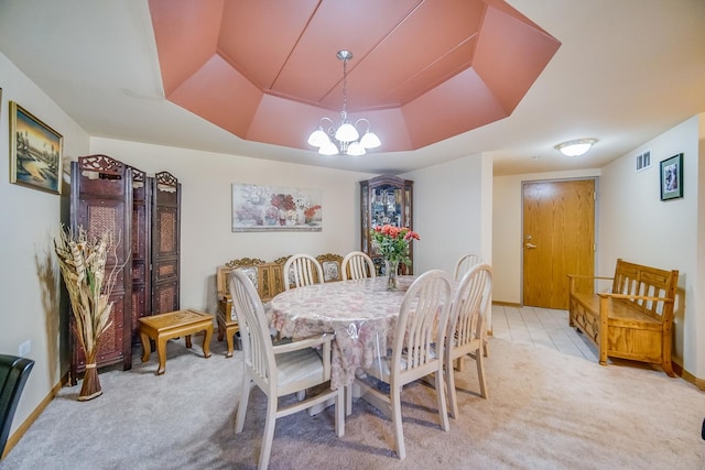 11850 Windemere Ct Unit 103, Orland Park, IL 60467 - carpeted dining area with visible vents, baseboards, a raised ceiling, an inviting chandelier, and tile patterned flooring