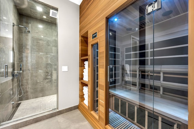 400 W Huron St Unit 501, Chicago, IL 60654 - full bathroom with a stall shower, tile patterned flooring, a relaxing sauna, and baseboards