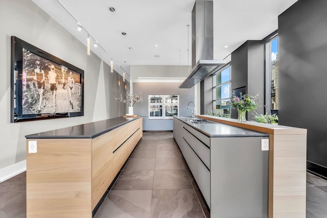 400 W Huron St Unit 501, Chicago, IL 60654 - kitchen featuring modern cabinets, island range hood, a large island, baseboards, and stainless steel gas stovetop