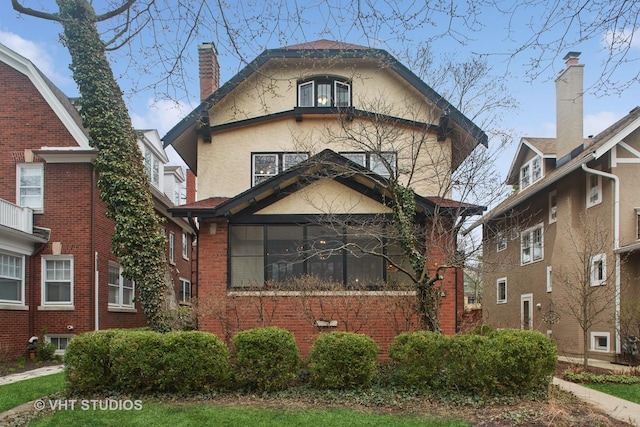 view of front of home featuring stucco siding and a chimney