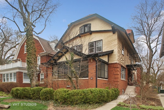 view of front of property with brick siding and stucco siding