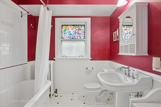 full bathroom with toilet, shower / tub combo, and wainscoting