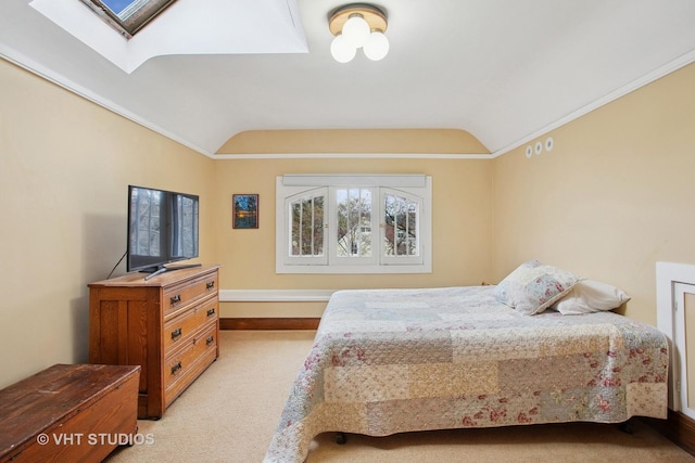 bedroom with light carpet, vaulted ceiling with skylight, and ornamental molding