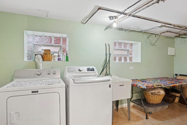 washroom with laundry area, light tile patterned floors, and washer and clothes dryer